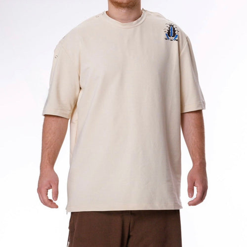 Person wearing a beige t-shirt and brown pants on a white background